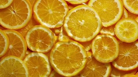 Super slow motion of orange slices with ice rotating in water, black background Stock Footage 259727606