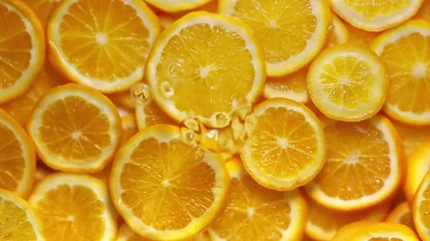 Super slow motion of orange slices with ice rotating in water, black background Stock Footage 274455971