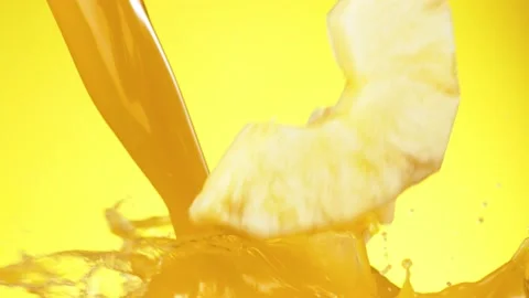 Super slow motion of pineapple slices falling into juice Stock Footage 151956933