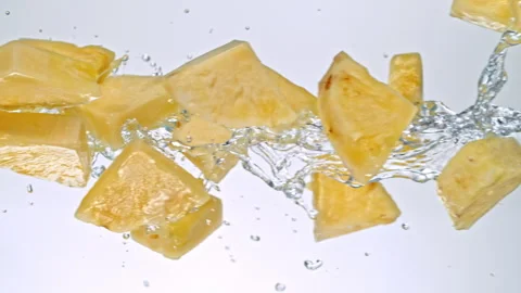 Super Slow Motion of Pineapple Slices Flying with Splashing Water at 1000fps on Stock Footage 303810811