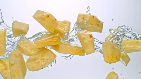Super Slow Motion of Pineapple Slices Flying with Splashing Water at 1000fps on Stock Footage 303964470