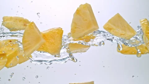 Super Slow Motion of Pineapple Slices Flying with Splashing Water at 1000fps on Stock Footage 304090361
