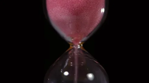 Super slow motion, Pink Sand Cascading Through Hourglass, Cinematic Slowmotion Stock Footage 330273616