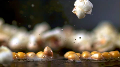 The super slow motion of the popcorn grain explodes with bubbles of oil. Filmed Stock Footage 154717819