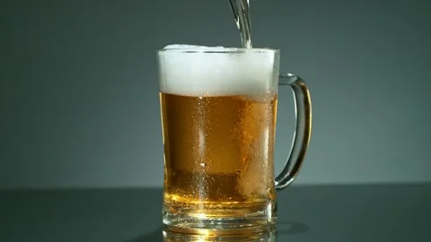 Super slow motion of pouring beer into pint at high speed. Stock Footage 265898322