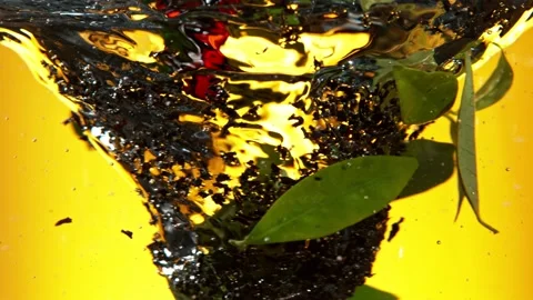 Super slow motion of pouring black tea into water in twister shape. Stock Footage 192277371