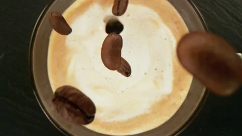 Super slow motion of pouring coffee beans into cup with camera follow. Stock Footage 148683986