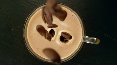 Super slow motion of pouring coffee beans into cup. Stock Footage 148693938