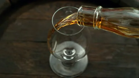 Super slow motion of pouring cognac into glass with speed motion Stock Footage 237162508