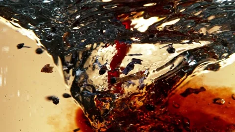 Super slow motion of pouring fruit tea into water in twister shape. Stock Footage 192747535