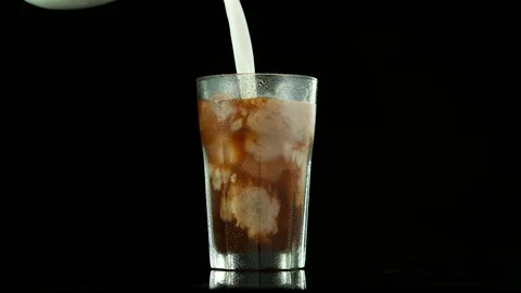Super slow motion of pouring ice coffee into glass Stock Footage 129599646