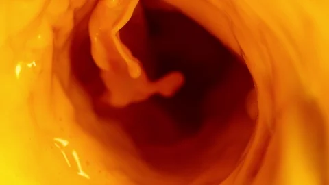 Super slow motion of pouring orange juice in twister shape Stock Footage 113488892