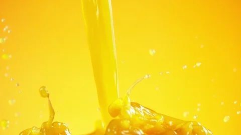 Super slow motion of pouring orange juice isolated on coloured background Stock Footage 128568131