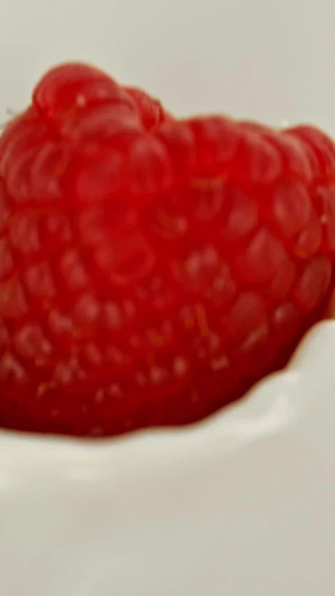 Super Slow Motion of Pouring Raspberry into Milk, Splashing. Stock Footage 297747497