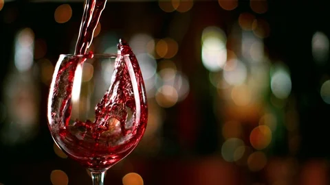 Super slow motion of pouring red wine from bottle into goblet. Stock Footage 116559314
