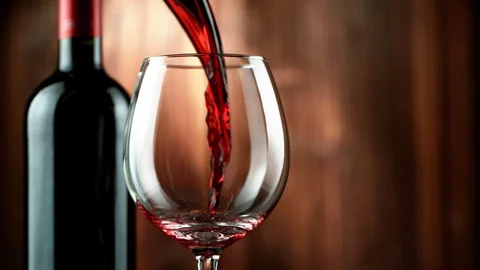 Super slow motion of pouring red wine into glass in detail. Stock Footage 122243150