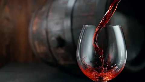 Super slow motion of pouring red wine into glass with camera motion Stock Footage 146215400