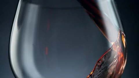 Super slow motion of pouring red wine into glass in detail. Stock Footage 155393440