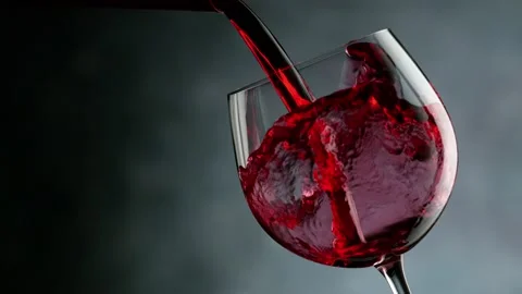 Super slow motion of pouring red wine into glass in detail, speed ramp effect Stock Footage 163186566