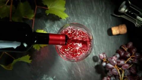 Super Slow Motion of Pouring Red and White Wine Into Glass. Stock Footage 164374831