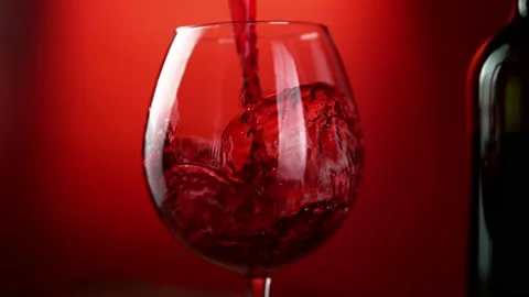 Super slow motion of pouring red wine into glass with rotate motion Stock Footage 165295838