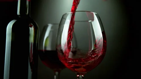 Super slow motion of pouring red wine into glass with rotate motion Stock Footage 165296250