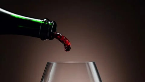 Super slow motion of pouring red wine into glass with camera motion Stock Footage 165298015