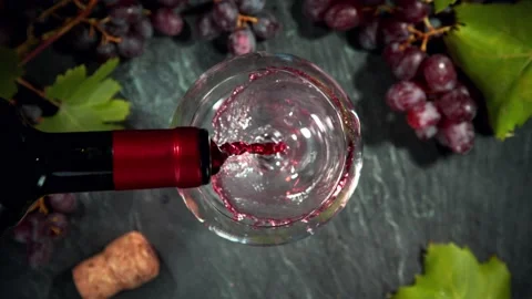 Super slow motion of pouring red wine into glass. Stock Footage 168936395