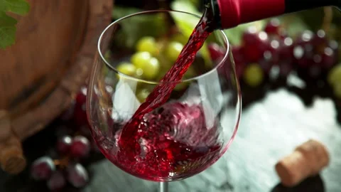 Super slow motion of pouring red wine into glass in detail. Stock Footage 168936605