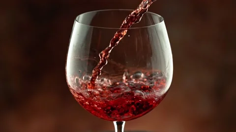 Super slow motion of pouring red wine into glass with speed motion Stock Footage 231986725