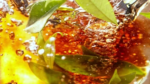 Super slow motion of pouring tea into water in twister shape. Stock Footage 186730221