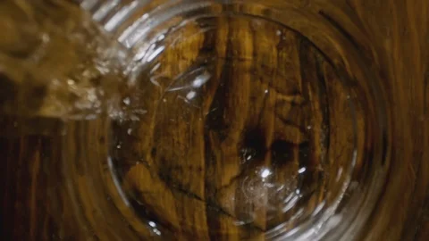 Super Slow Motion Of Pouring Whiskey Into Glass and Ice Dropped Stock Footage 112226483