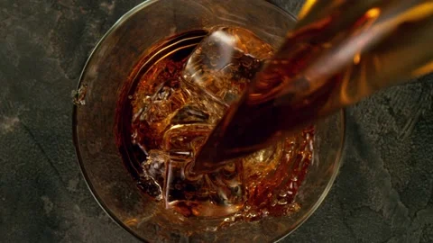 Super slow motion of pouring whiskey or rum Stock Footage 148693659