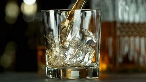 Super slow motion of pouring whiskey or rum with camera motion Stock Footage 166113324