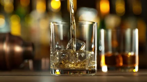 Super slow motion of pouring whiskey into glass. Stock Footage 231029662