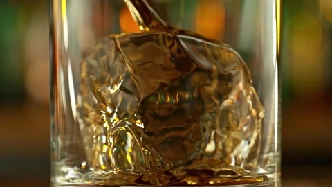 Super slow motion of pouring whiskey into glass. Stock Footage 233112082