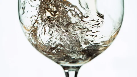 Super slow motion of pouring white wine in detail, isolated on white background Stock Footage 120397033