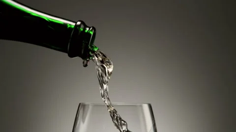 Super slow motion of pouring white wine into glass in detail. Stock Footage 165294583