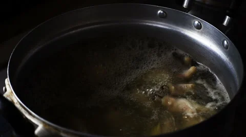 Super slow motion of put fresh chicken in boiling Thai soup Stock Footage 65883479
