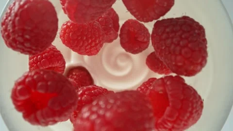 Super slow motion of raspberries falling into yoghurt cream Stock Footage 273879819