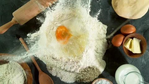 Super slow motion of raw egg falling into pile of flour. Stock Footage 132005207