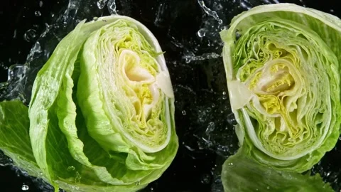 Super slow motion of raw salad head with water splash Video stock 281360415