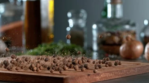 Super slow motion of rolling allspice balls on wooden board. Stock Footage 166968953