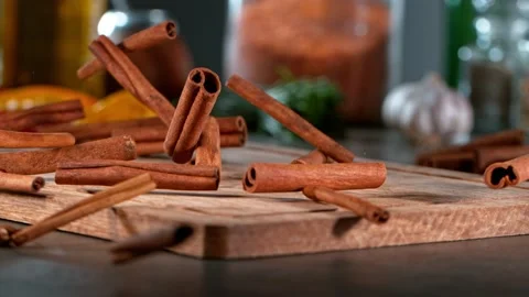 Super slow motion of rolling cinnamon spice on wooden board. Stock Footage 166970073
