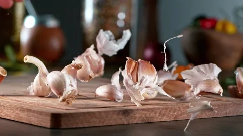 Super slow motion of rolling  garlic on wooden board. Stock Footage 166967354