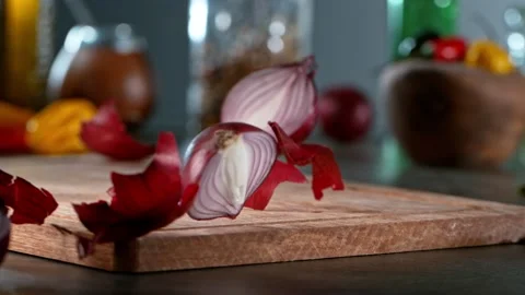 Super slow motion of rolling  onion on wooden board. Stock Footage 166966974