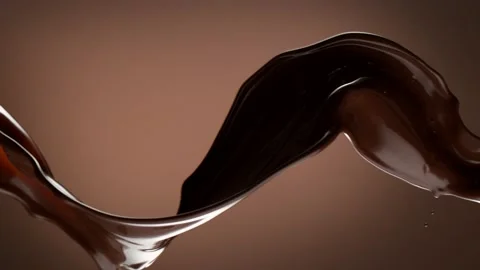 Super slow motion of rotating dark hot chocolate splashes Stock Footage 150938514