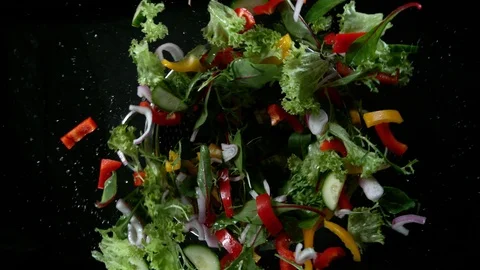 Super slow motion of rotating fresh mixed salad with water drops. Stock Footage 122862662