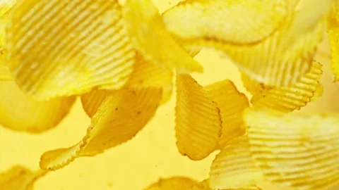 Super slow motion of rotating fried potatoes chips on black background Stock Footage 238439963