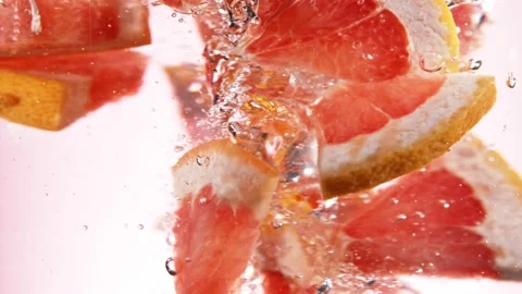 Super slow motion of rotating grapefruit slices underwater. Stock Footage 193316219